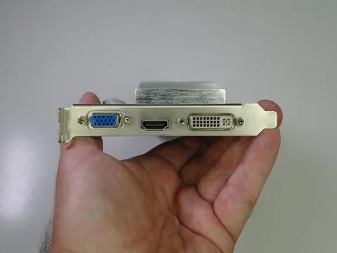 A man is holding the computer graphics card in his hand, close up Stock Photos