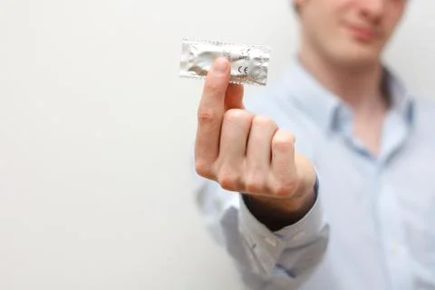 Man holding condom Stock Photos