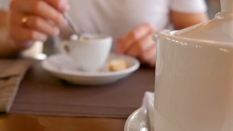 Man holding a cup of tea in hands and drinking. A cup of tea on a table. Close Stock Footage 108994314