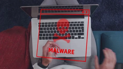 Man holding device activating red malware overlay on laptop, glitching while Stock Footage 335739579
