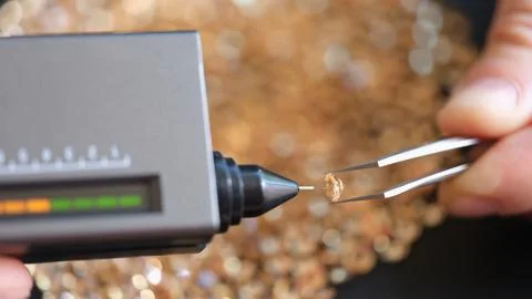Man holding diamond in hand using tweezers Stock Photos