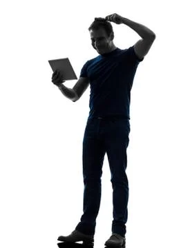 Man holding digital tablet  brushing hair silhouette Stock Photos