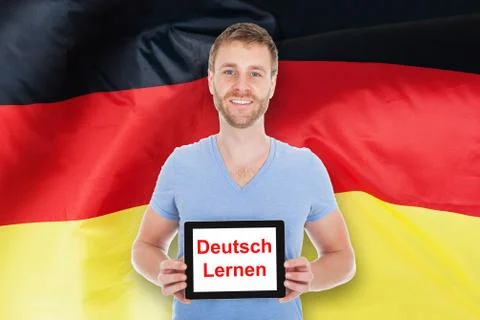 Man Holding Digital Tablet With Learn German Text 스톡 사진