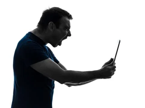 Man holding digital tablet  screaming angry furious silhouette Stock Photos