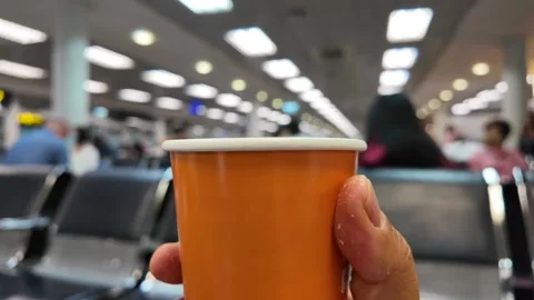 Man is holding disposable cup coffee  while waiting for boarding 库存影片 271127300