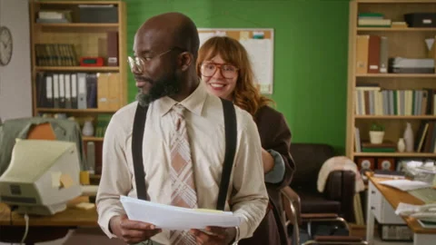 Man Holding Documents while Woman Having Fun in Retro Office Stock Footage 341419439