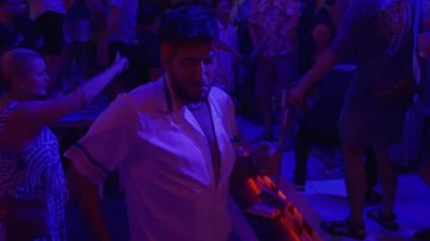 Man Holding Drink While Dancing at Nightclub Party Stock Footage 337886886