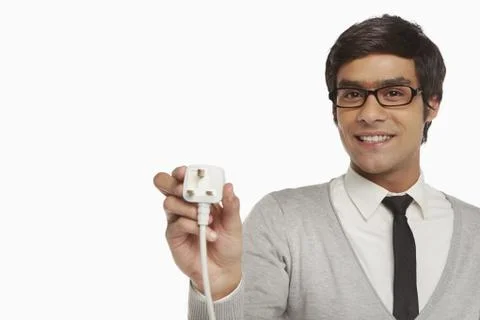 Man holding up an electrical plug Stock Photos