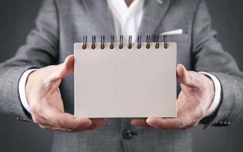 Man holding empty notepad. Space for your text Stock Photos