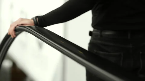 Man holding escalator handrail while going down in indoor space. 스톡 동영상 347781000