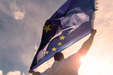Man holding EU Flag or European Union flag, concept picture Stock Photos