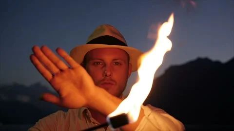 Man holding fire torch light playing with the flame in slow motion Video stock 64802325