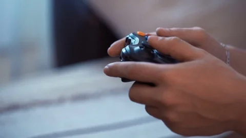 Man holding game controller playing video games Video stock 70122830