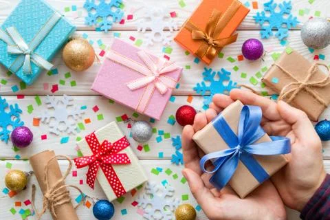 Man holding a gift box on the background of Christmas decorations Stock Photos