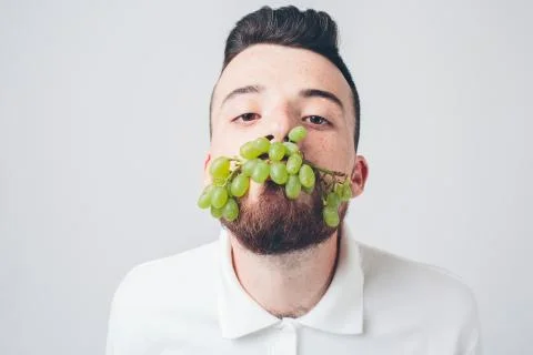Man holding grape, close up. concept. isolated on white Stock Photos