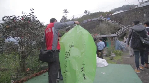 Man holding up green lantern - lantern festival Stock Footage 47285275