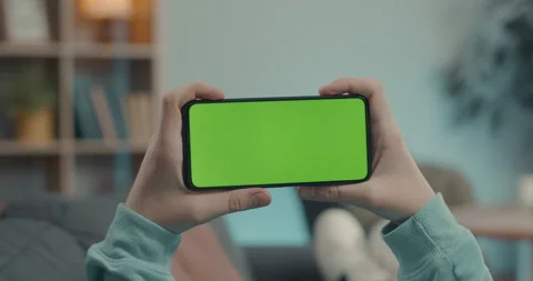 Man holding green screen mobile in horizontal position Stock Footage 167012188