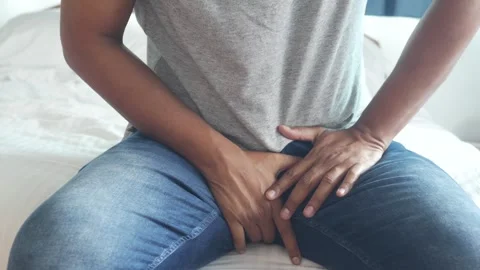 Man holding groin area while sitting on bed concerned medical issue discomf.. Vídeos de archivo 332744727