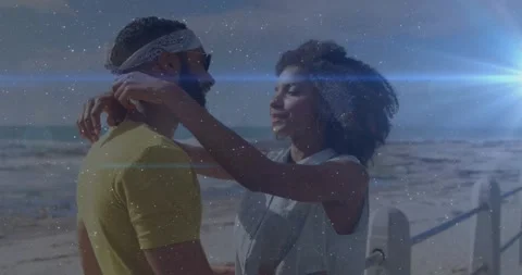 Man holding hand causing woman leaning for love fixing bandana hugging sun flare Stock Footage 329812715