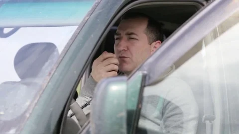 Man holding hand microphon and talking on radio in his car. Stock Footage 76215769