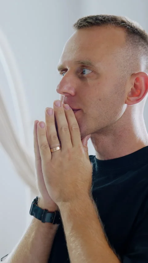 Man is holding hands in front of his face in praying position.  Stock Footage 304508770
