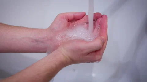 Man Holding Hands Under Running Water Stock Footage 330174645