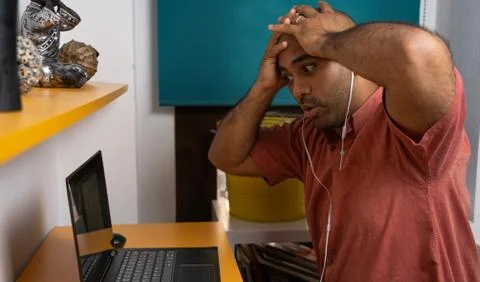 Man holding head using the computer Foto stock