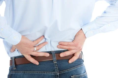 Man Holding his Back While Suffering From Back Pain Stock Photos