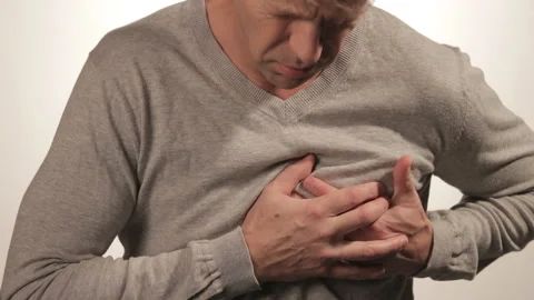 Man holding his chest with both hands, having heart attack or painful cramps, pr 動画素材 99573728