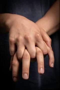 Man holding his own hands together Fotos de archivo