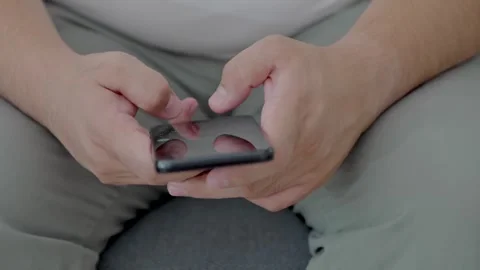 Man holding iPhone with chat application WhatsApp on the screen Stock Footage 307607864