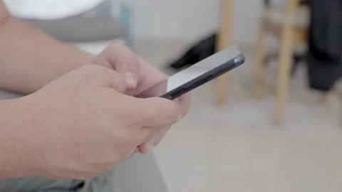 Man holding iPhone with chat application WhatsApp on the screen Stock Footage 307607868