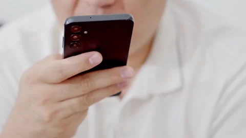 Man holding iPhone with chat application WhatsApp on the screen Stock Footage 307607876