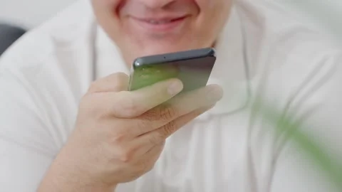 Man holding iPhone with chat application WhatsApp on the screen Stock Footage 307607887