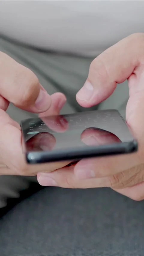 Man holding iPhone with chat application WhatsApp on the screen Stock Footage 307607888