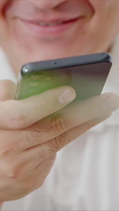 Man holding iPhone with chat application WhatsApp on the screen Stock Footage 307607889