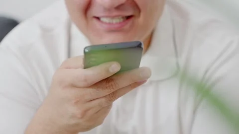 Man holding iPhone with chat application WhatsApp on the screen Stock Footage 307607891