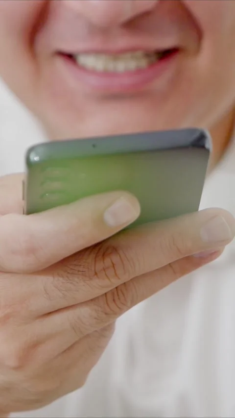 Man holding iPhone with chat application WhatsApp on the screen Stock Footage 307607895