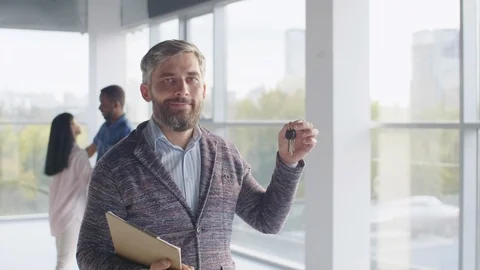 Man holding keys from new flat and smiling Stock-Footage 125717519