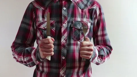Man holding knife and fork Stock Footage 100667734
