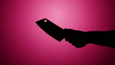 Man holding knife axe close-up, shadow silhouette of hand with weapon on pink Stock Footage 170586653