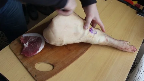 Man cutting meat on chopping board stock photo