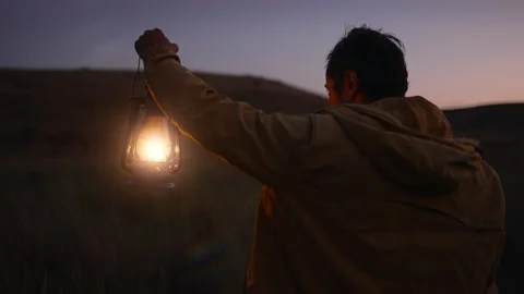 Man holding lantern on nature Stock Footage 280361007