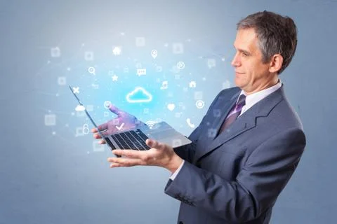 Man holding laptop with cloud based system notifications Stock Photos