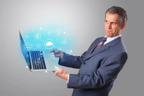 Man holding laptop with cloud based system concept Stock Photos