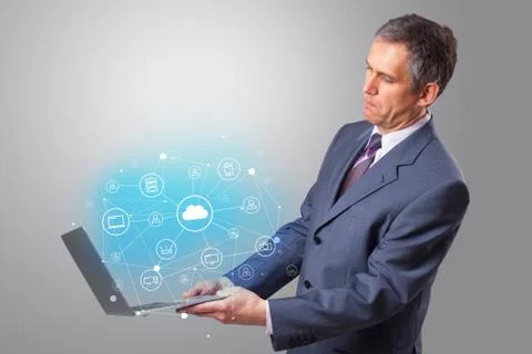 Man holding laptop with cloud based system concept Foto stock