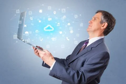 Man holding laptop with cloud based system notifications Stock Photos