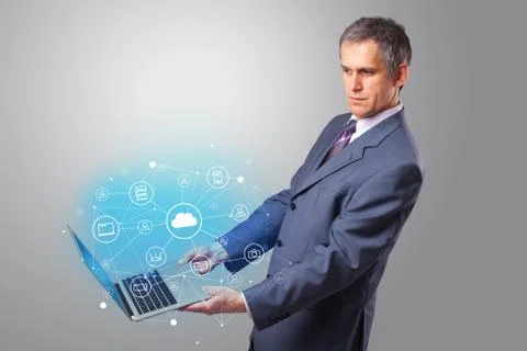 Man holding laptop with cloud based system concept Foto stock