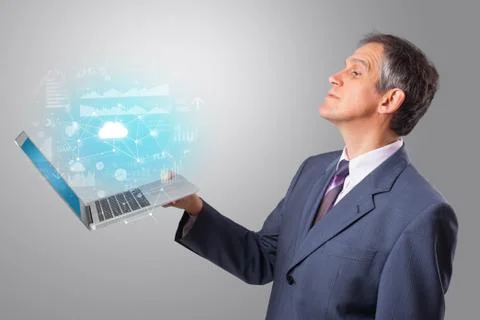 Man holding laptop with cloud based system concept Stock Photos