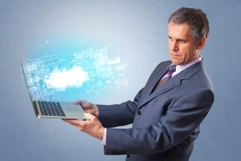 Man holding laptop with cloud based system notifications Stock Photos